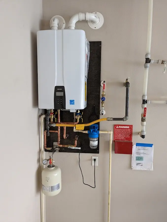Professional plumber installing copper piping in a Chinle home